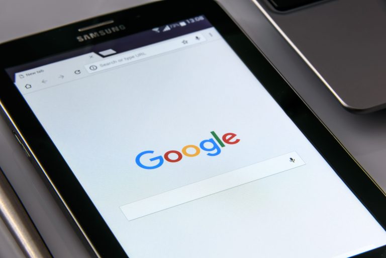 Close-up of a tablet displaying Google's search screen, emphasizing technology and internet browsing