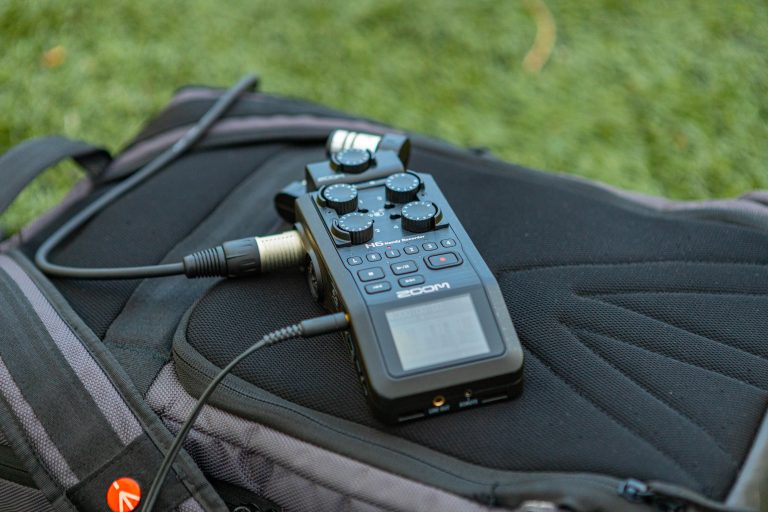 Close-up of a portable audio recorder on a backpack, ideal for outdoor recording